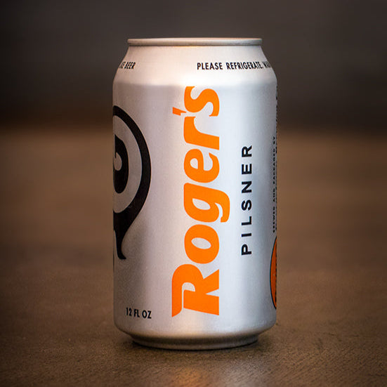 Can of Roger's pilsner beer by Georgetown Brewing on the cement floor of the tasting room