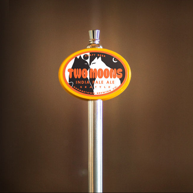 Two Moons India Pale Ale tap handle against a brown background