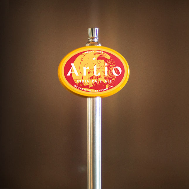 yellow oval tap handle with the Artio ipa label