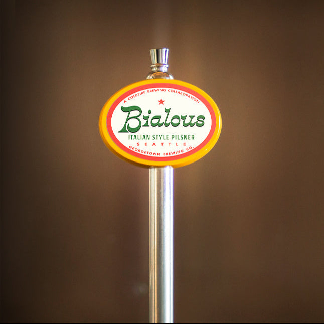 a yellow oval tap handle with the Bialous Italian Pilsner label