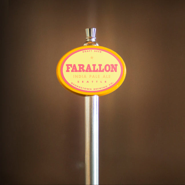 yellow oval beer tap handle with 'Farallon' label against a brown background