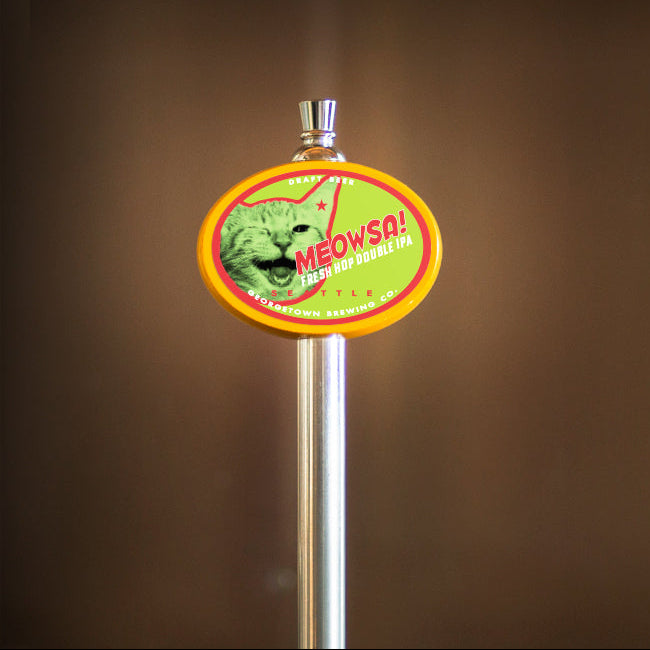 Metallic beer tap handle with a colorful label featuring a cat graphic with the text Meowsa Fresh Hop Double IPA