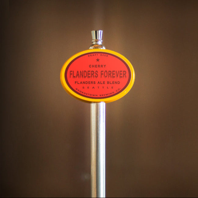 Beer tap handle with 'Flanders Forever' label on a blurred background