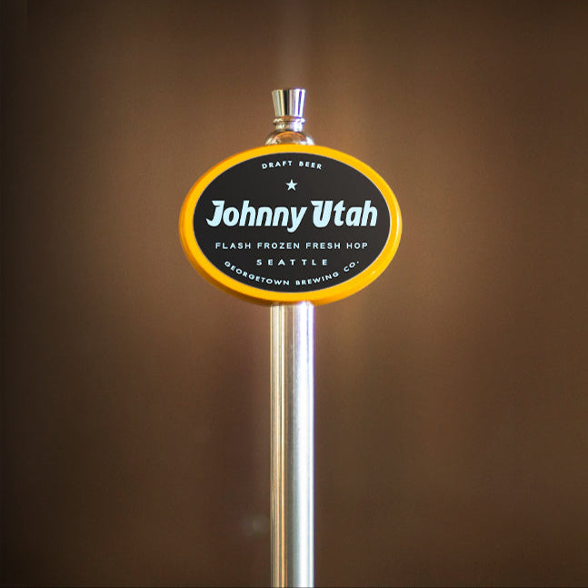 yellow beer tap handle with 'Johnny Utah' branding on a brown background