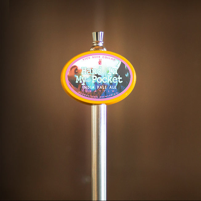 Beer tap handle with Hand in my Pocket label on a brown background