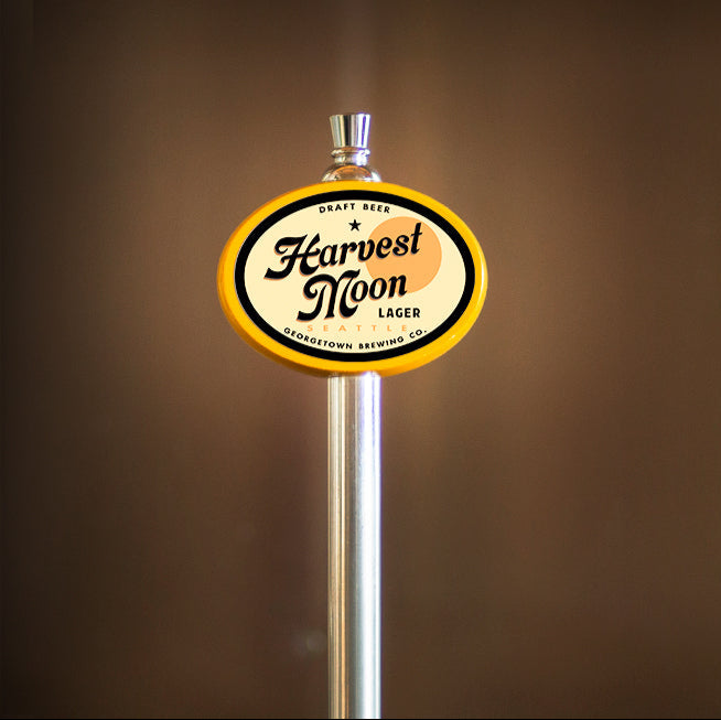 Harvest Moon Lager tap handle against a brown background