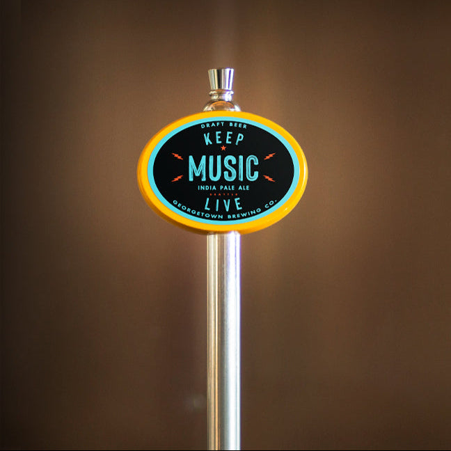 tap handle with a circular sign reading 'Keep Music Live' against a brown background