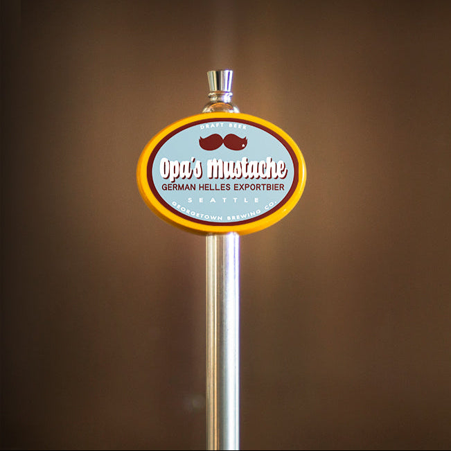 Beer tap handle with Opa's Mustache label on a brown background