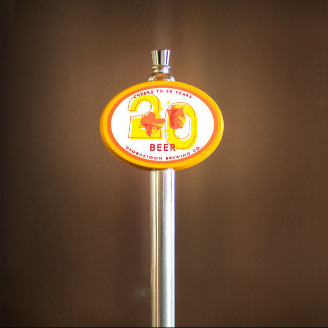 yellow oval tap handle with 20 Year beer tap label