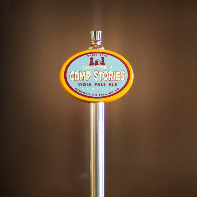 Camp Stories India Pale Ale tap handle against a brown background