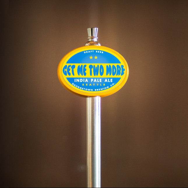 Beer tap handle with 'Get Me Two More' label on a brown background
