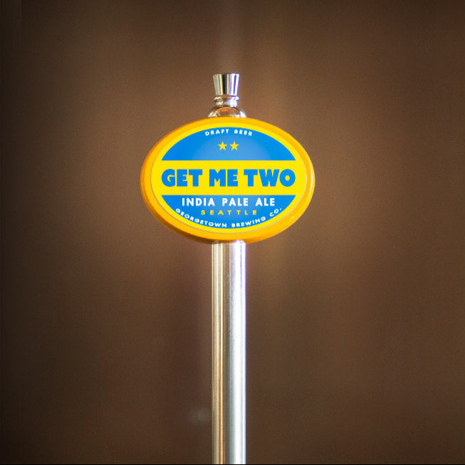 Beer tap handle with 'Get Me Two' label on a brown background