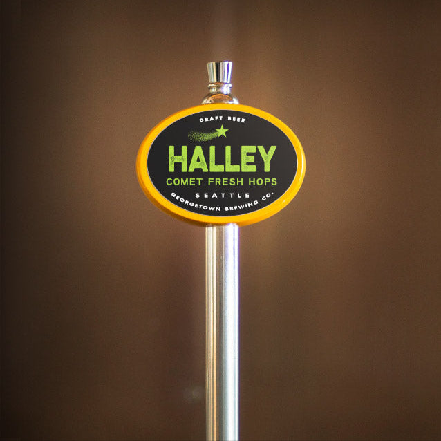 yellow oval beer tap handle with 'Halley' branding on a brown background