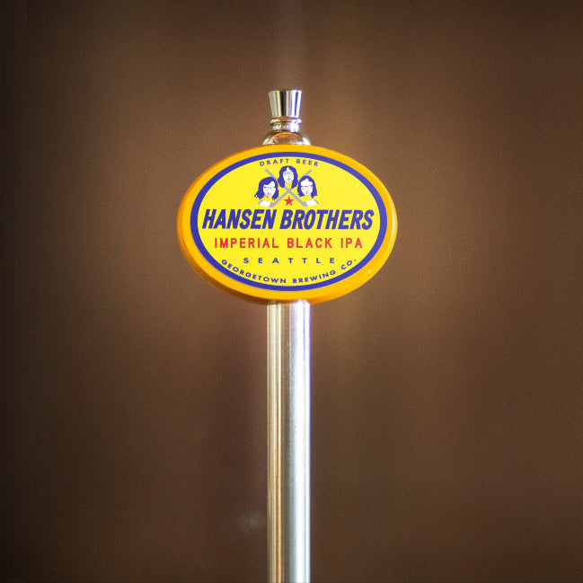Hansen Brothers Imperial Black IPA tap handle against a brown background
