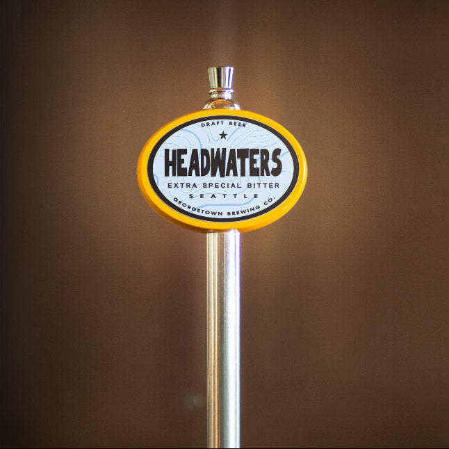 beer tap handle with 'Headwaters' label on a brown background