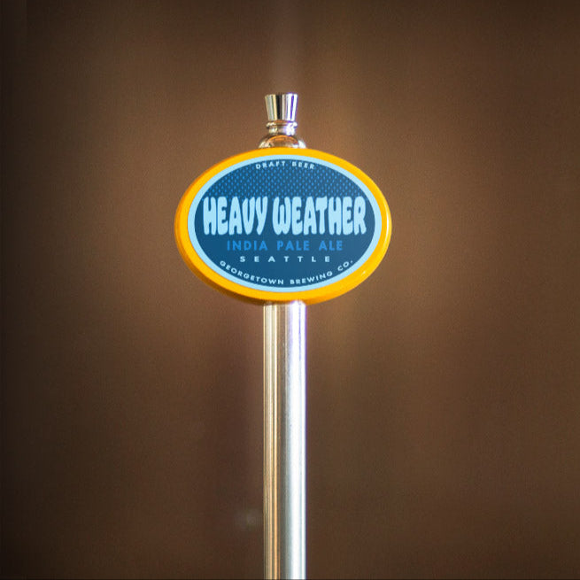Heavy Weather India Pale Ale tap handle against a brown background