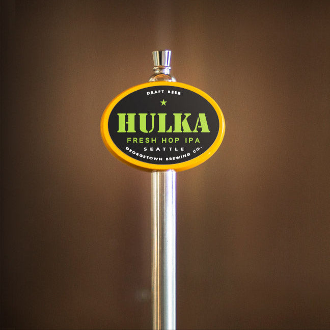 Hulka Fresh Hop IPA beer tap handle on a brown background