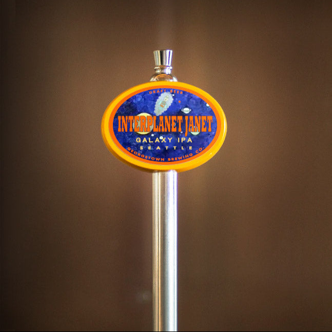 Beer tap handle with Interplant Janet ipa label on a brown background