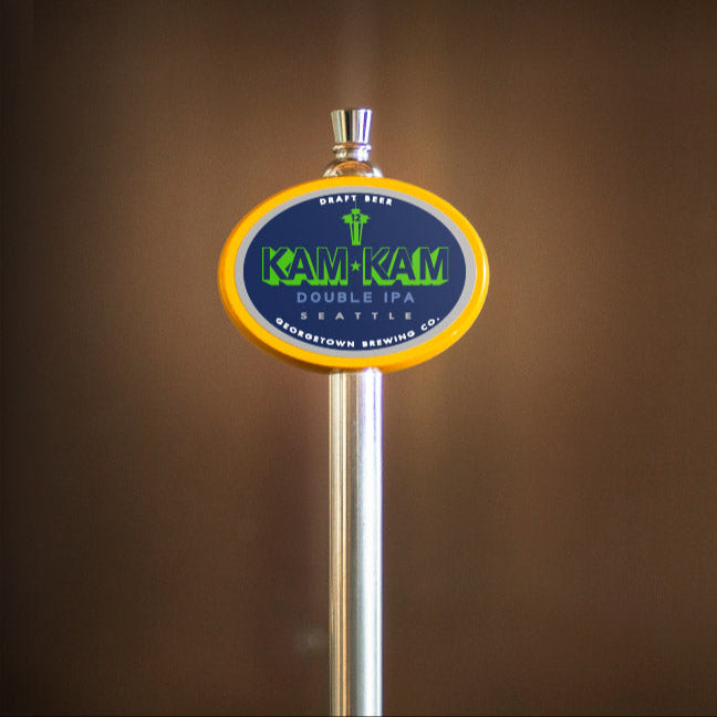 Kam-Kam Double IPA beer tap handle against a brown background