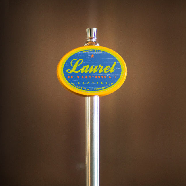 Beer tap handle with 'Laurel' branding on a blurred background