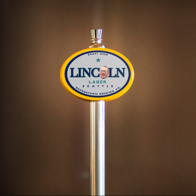 Lincoln Lager beer tap handle against a brown background