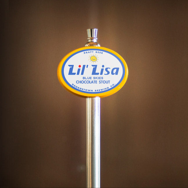 Lil' Lisa beer tap handle against a brown background