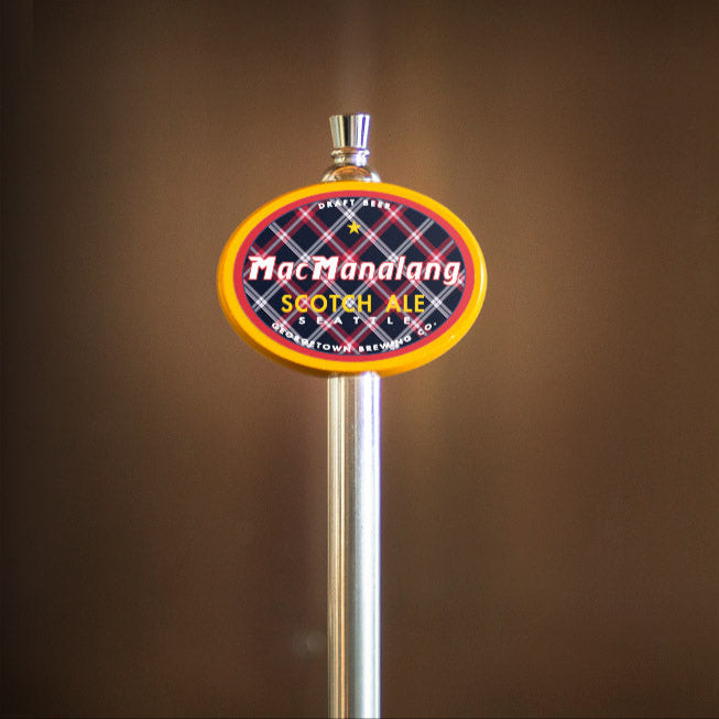Beer tap handle with 'MacManalang' branding against a brown background