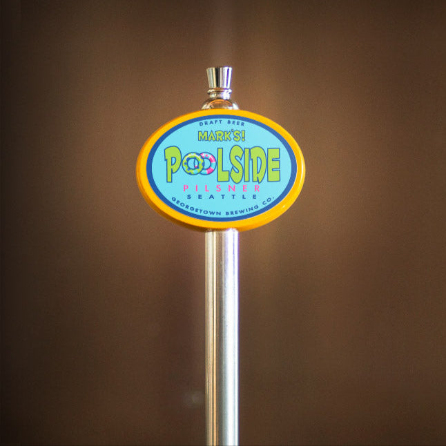 beer tap handle with 'Poolside' branding against a blurred background