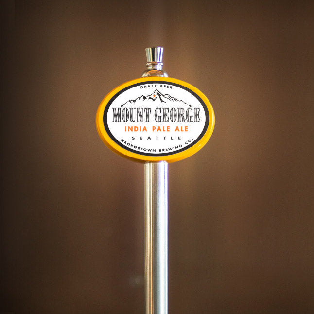 Mount George India Pale Ale tap handle against a brown background