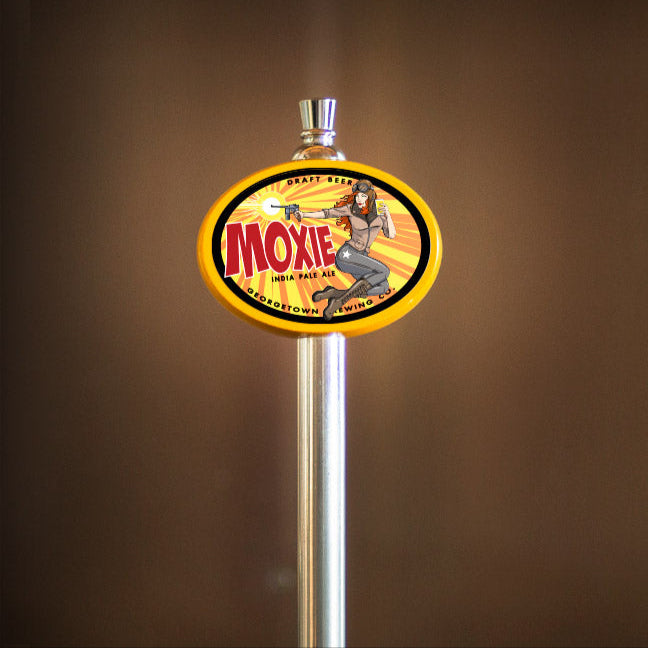 Moxie beer tap handle on a brown background