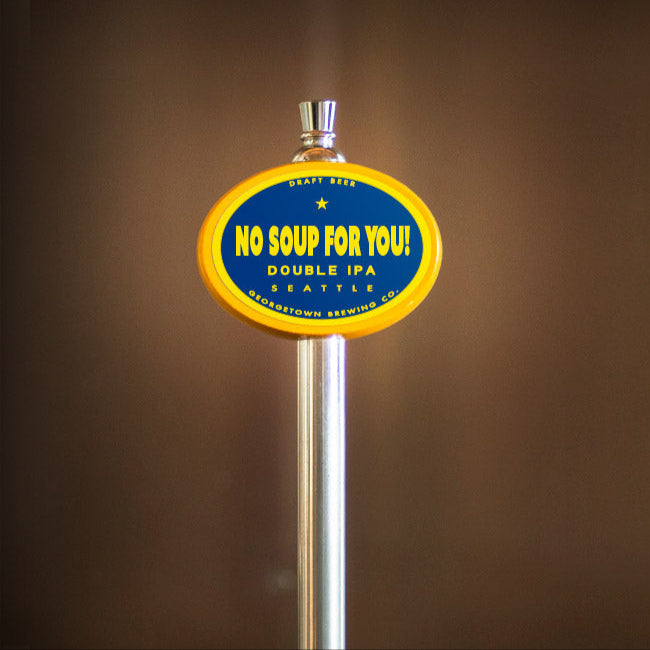 Beer tap handle with 'No Soup For You!' label on a brown background