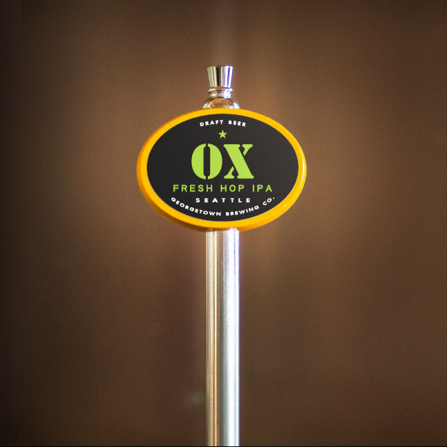 OX Fresh Hop IPA beer tap handle on a brown background