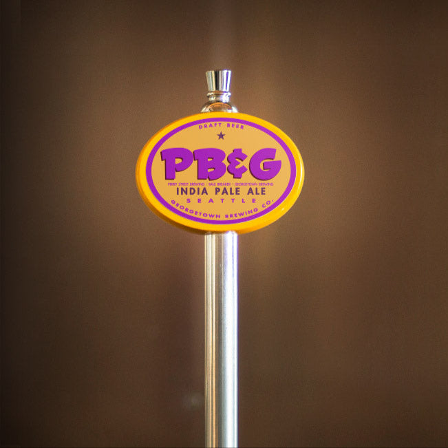 PB&G India Pale Ale tap handle against a brown background