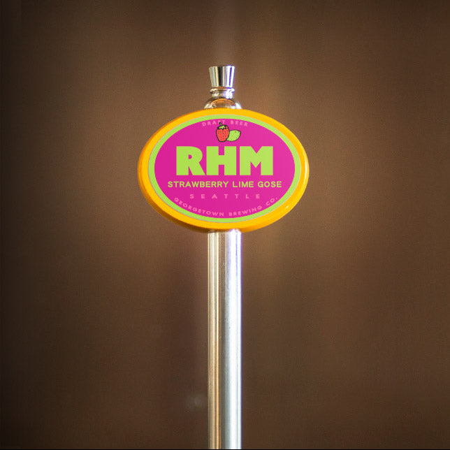 beer tap handle with a colorful RHM label on a brown background