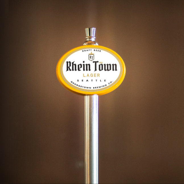Beer tap handle with 'Rhein Town' label against a brown background