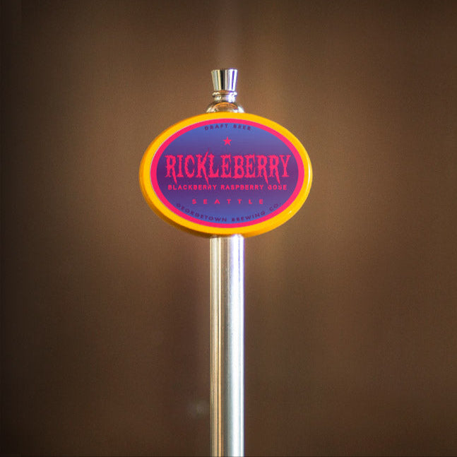 Metallic beer tap handle with 'Rickleberry' branding against a blurred background