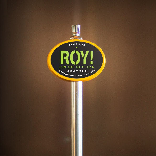 Beer tap handle with 'ROY!' branding against a brown background
