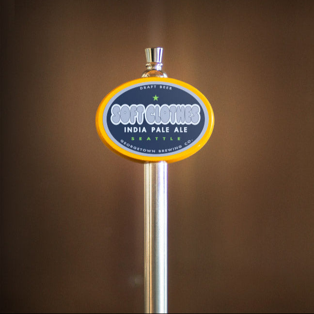 Beer tap handle with aSoft Clothes label on a brown background