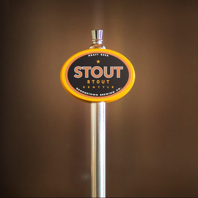 Stout beer tap handle with a brown background