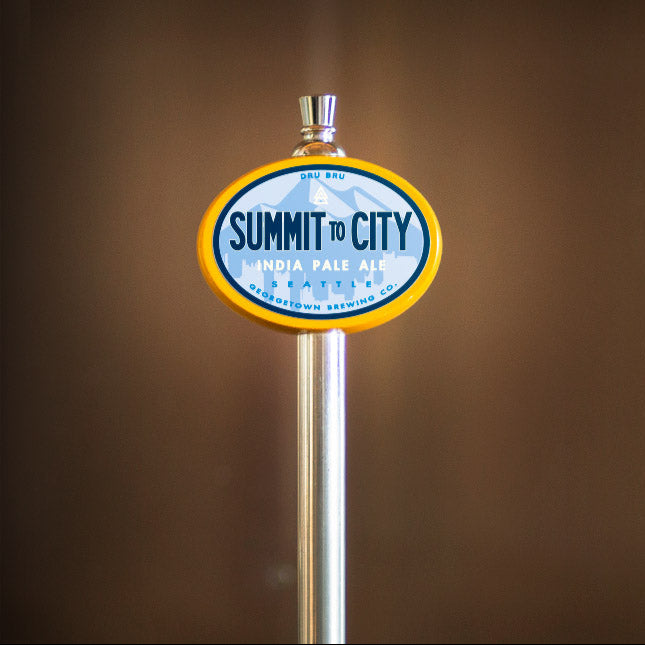 Summit to the City beer tap handle against a brown background