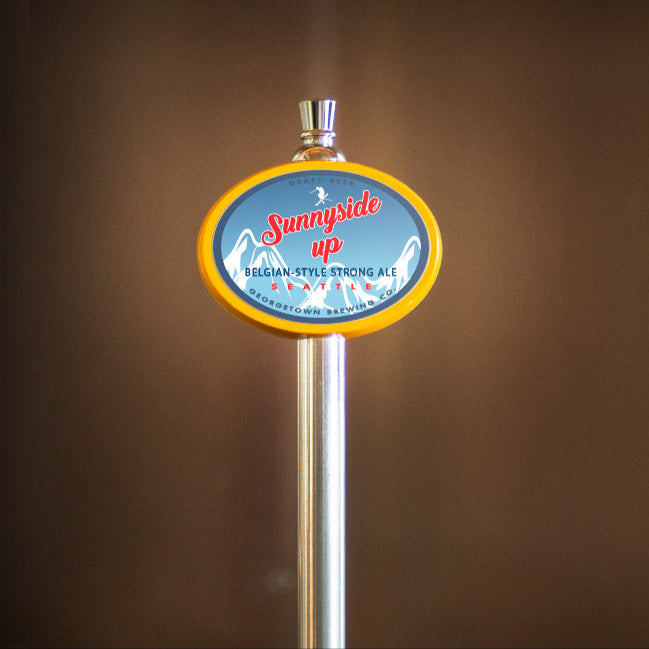 Metallic beer tap handle with a colorful Sunnyside Up label against a brown background