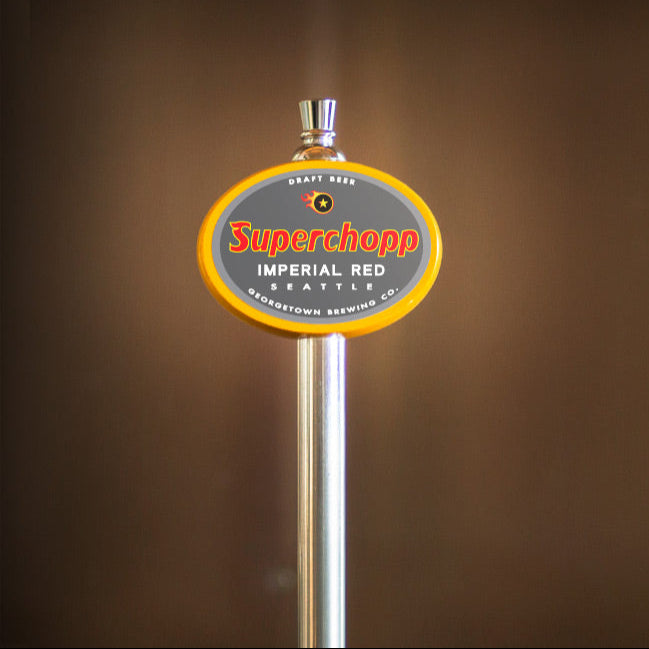 Superchopp Imperial Red beer tap handle on a brown background