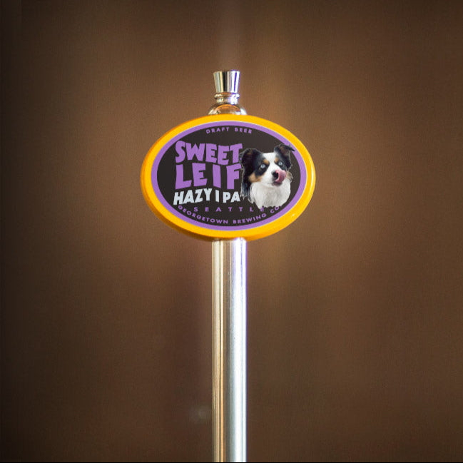 Beer tap handle with 'Sweet Leif Hazy IPA' label on a brown background