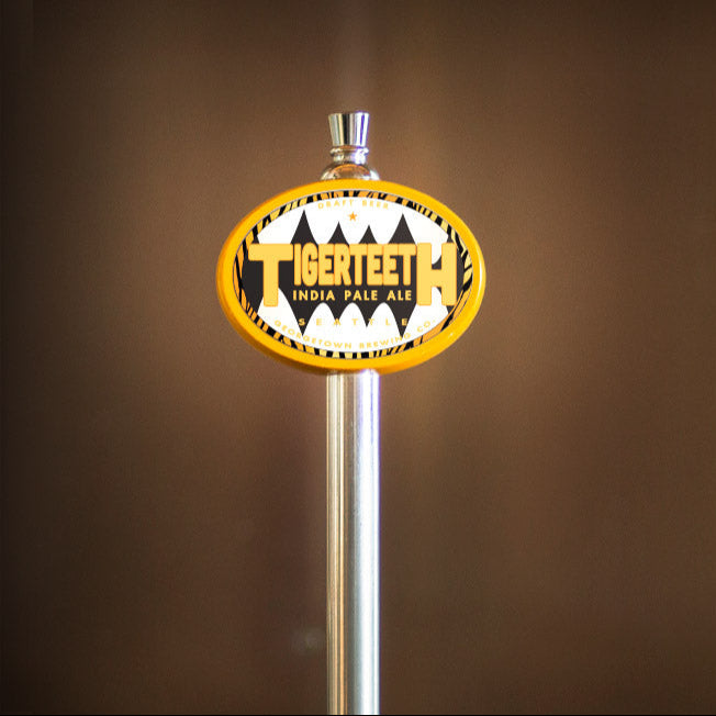Tiger Teeth beer tap handle on a brown background