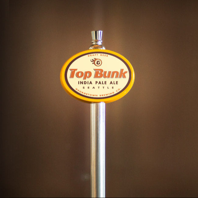 Top Bunk India Pale Ale beer tap handle against a brown background