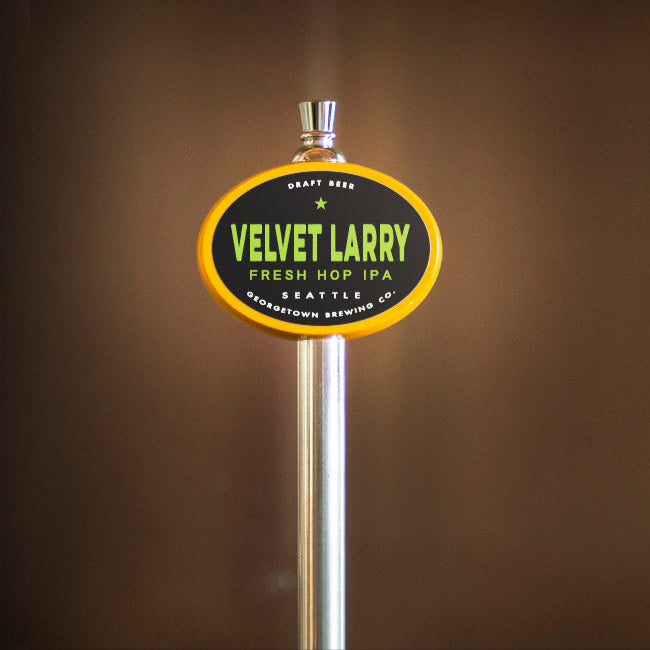 Beer tap handle with 'Velvet Larry' branding on a brown background
