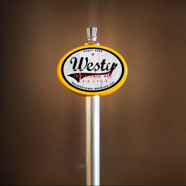 Westy beer tap handle with a blurred brown background