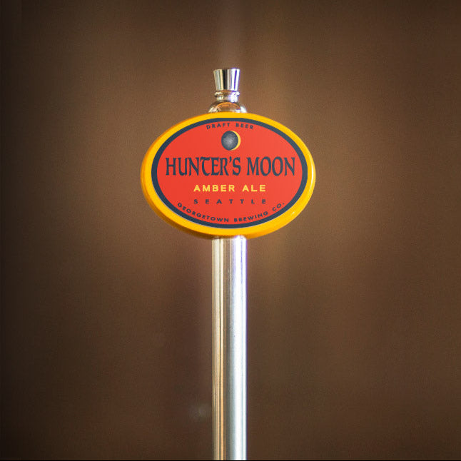 Hunter's Moon Amber Ale tap handle against a brown background