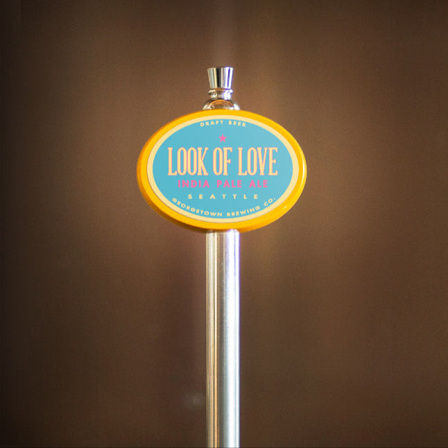 tap handle with a 'Look of Love' sign against a brown background