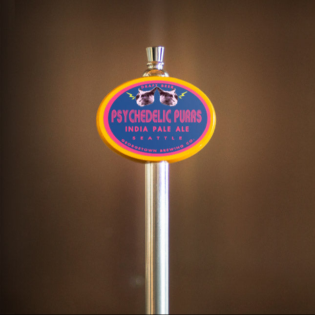 Beer tap handle with 'Psychedelic Purrs' label against a brown background